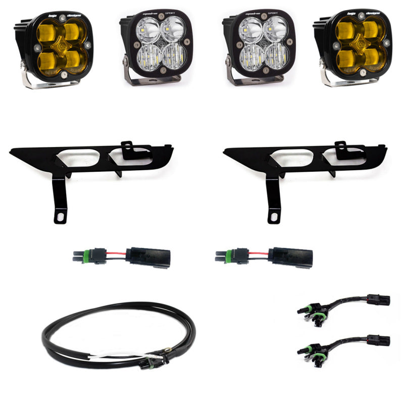 The image showcases the Baja Designs 2021+ Ford F-150 Sport Series Fog Pocket Kit - Amber, which includes three LED pods thoughtfully designed for the Ford F-150. The kit comes complete with mounting brackets and wiring harnesses, with each pod featuring two amber and two clear lenses. All components are neatly organized in separate groups on a white background.